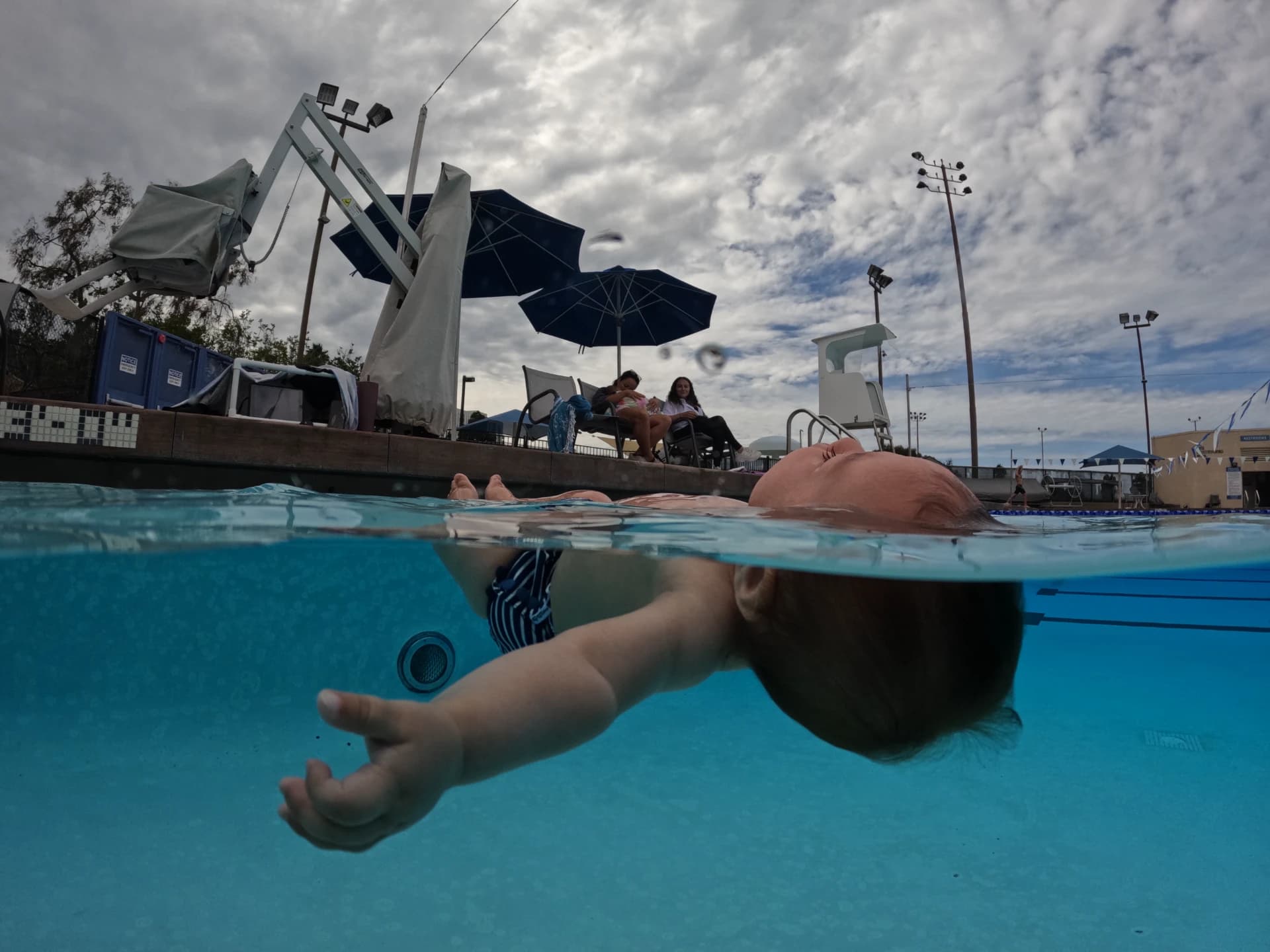 Instructor teaching a child to float safely during ISR swim lesson